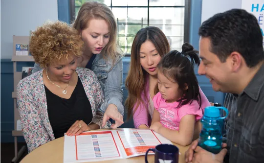 New members look at a program book