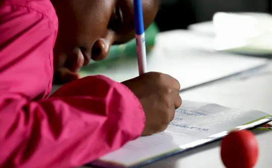 Student works on her writing during power scholars academy