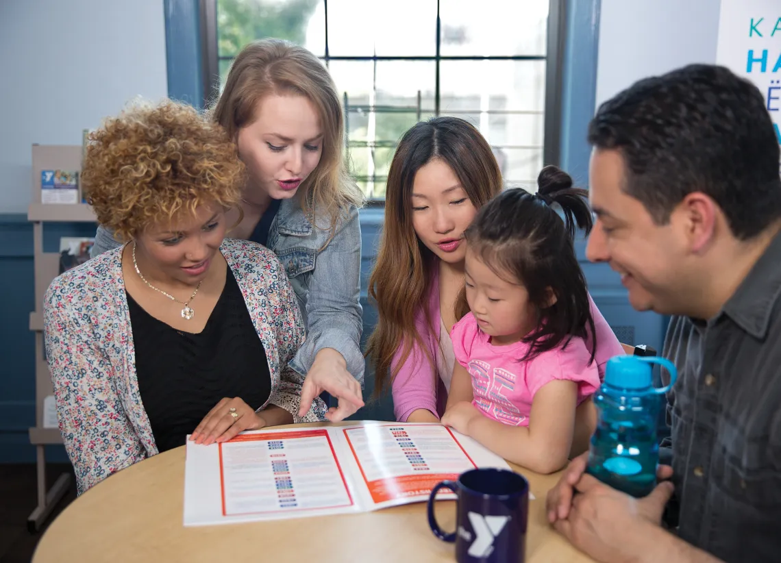 Members look at a program guide